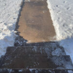 sidewalk in winter cleared of snow